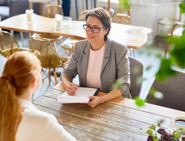 Hiring waitress Confident owner of cafe interviewing young specialist